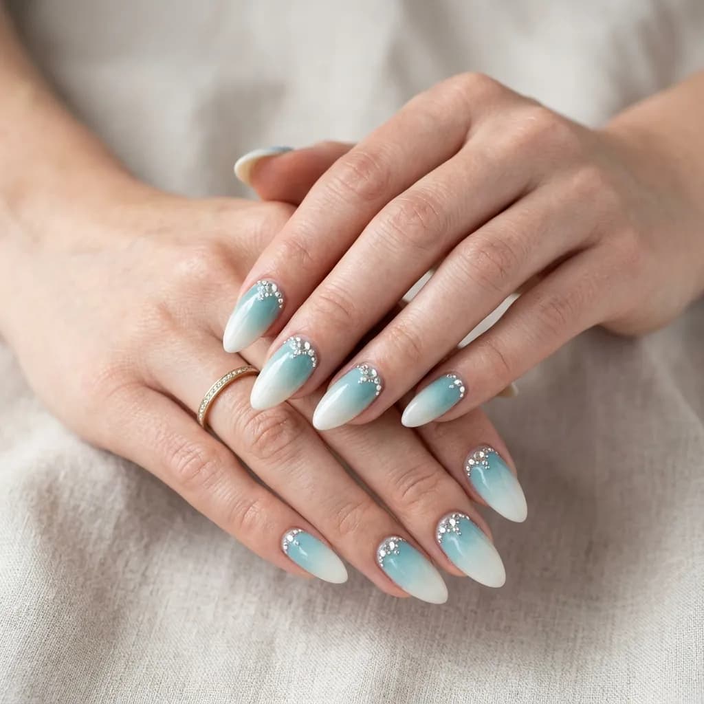 Teal to white ombre nail art with crystal accents